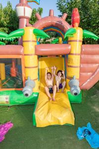 two people riding on a inflatable play structure at Domaine Chalets Larlapean in Saint-Martin-dʼArrossa