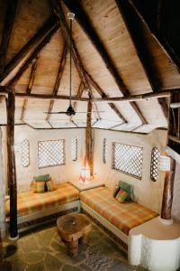 an attic room with two beds and a table at Natura Cabana Boutique Hotel & SPA by Mint in Cabarete