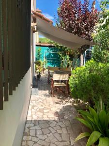 a patio with a table and an umbrella at Da Scilla in Punta Marina