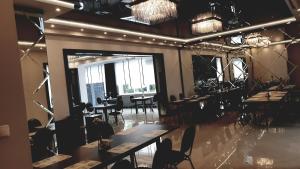 a restaurant with tables and chairs and a large window at Hotel Bukowiec in Legionowo