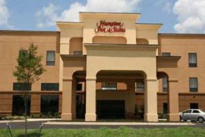 a building with a car parked in front of it at Hampton Inn & Suites West Point in West Point