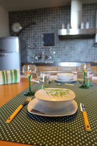 a table with a bowl and plates and glasses on it at B&B Margè in Oltrona di San Mamette