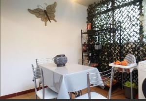 a room with a table and a butterfly on the wall at Alegria Apartment in Porto