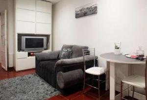 a living room with a couch and a table at Alegria Apartment in Porto