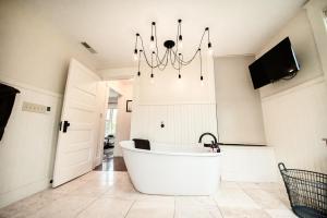 a bath tub in a bathroom with a chandelier at Studio 555 in Granville