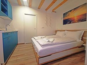 a small bedroom with a bed and a sink at Ribiška hiša - Old Piran Fisherman's House in Piran