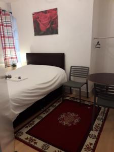 a bedroom with a bed and a table and a table at 20 East Tenter Street in London