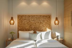 a bedroom with two white beds and two lights at S & O Villas Corfu in Dassia