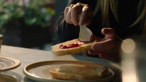 a person eating a piece of bread with a fork at Home Hotel Fregatten in Varberg