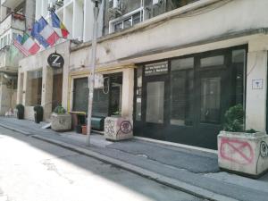 a street with a building with graffiti on the side of it at Old Town Studio by MRG Apartments in Bucharest