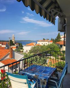 a table and chairs on a balcony with a view at Lina Vranković Apartments in Hvar
