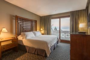 a hotel room with a bed and a large window at Enjoy Viña Del Mar in Viña del Mar