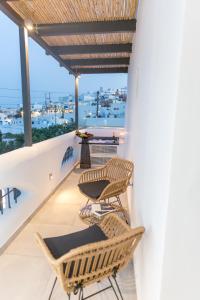 2 chaises et une table sur un balcon dans l'établissement Margarita Hotel, à Firostefani