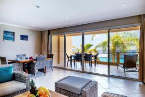 a living room with a view of the ocean at Oceanfront Apartment Yellow Tail Snapper at Den Laman in Kralendijk