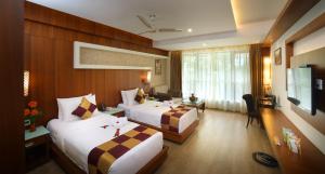 Postel nebo postele na pokoji v ubytování Amber Dale Luxury Hotel & Spa, Munnar