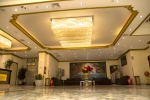 a lobby with a large ceiling with a chandelier at Swan Hotel in Lima