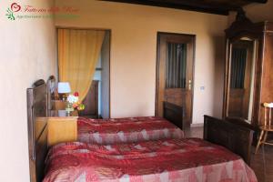 a bedroom with two beds in a room at Fattoria Delle Rose in Salussola