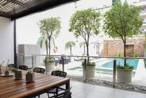 a patio area with tables, chairs, and umbrellas at Argenta Suites Belgrano in Buenos Aires