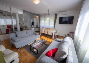 a living room with couches and a dining room at Stella House Mrežnica in Duga Resa