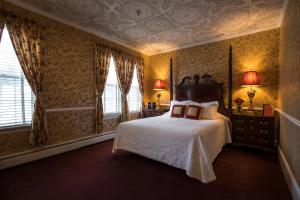 a bedroom with a large bed and a large window at Stafford's Bay View Inn in Petoskey