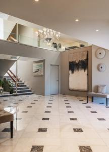 a large room with a staircase and a ceiling at Pantheon City Hotel in Gythio