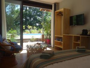 a bedroom with a bed and a large sliding glass door at La Grange Océane SPA & Piscine chauffée en saison in Lège-Cap-Ferret