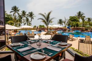 
a table set up with chairs and tables in front of a beach at Crocs Resort & Casino in Jacó
