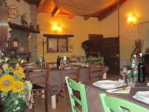 a dining room with tables and chairs with flowers at Fattoria Bertaccini in Cesena