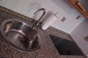 a sink in a bathroom with a roll of toilet paper at Apartment Key in Rovinj