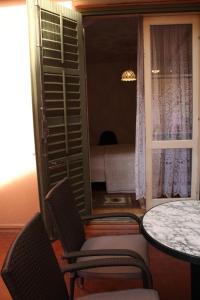 a room with a table and chairs and a window at Apartment Key in Rovinj