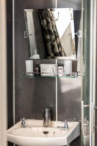 a bathroom with a sink and a mirror at Ladysmith Guest House in Ullapool