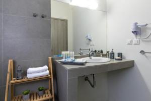 a bathroom with a sink and a mirror at Rose Central Master Bedroom Apartment in Rhodes Town