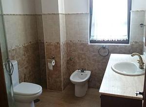 a bathroom with a toilet and a sink at LOS LAURELES in Cudón +25 photos
