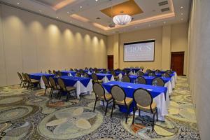 a banquet hall with blue tables and chairs at Crocs Resort & Casino in Jacó +110 photos