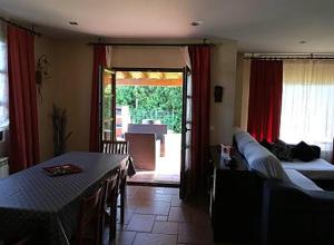 a living room with a table and a couch at LOS LAURELES in Cudón