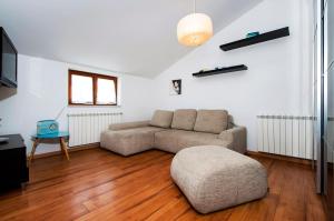 a living room with a couch and a table at Apartments Vanda in Rovinj