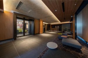an office lobby with a row of tables and chairs at Shizutetsu Hotel Prezio Kyoto Karasumaoike in Kyoto
