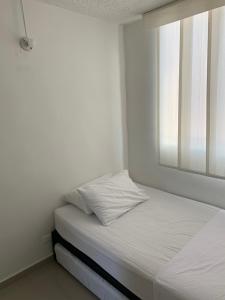 En eller flere senge i et værelse på Apartamento - Tocaima
