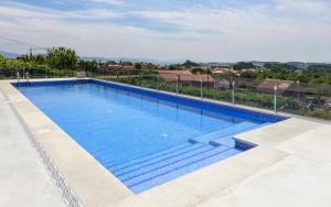 a large blue swimming pool on top of a building at Apartamentos Onzamar in Sanxenxo