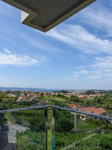 a view of a city from the balcony of a building at Apartamentos Onzamar in Sanxenxo