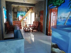 a room with chairs and a staircase in a house at Leyte Seaview Stay in Himay-añgan
