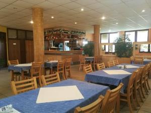 a dining room with blue tables and wooden chairs at Kavana i sobe Monika in Grabrovnik