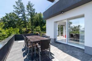 a patio with a wooden table and chairs at Villa Sol in Lovran
