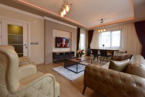 a living room with couches and a dining room at İnanlar Airport Residence in Trabzon