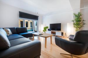 a living room with a couch and a table at Les Lofts St-Roch - Par Les Lofts Vieux-Québec in Quebec City