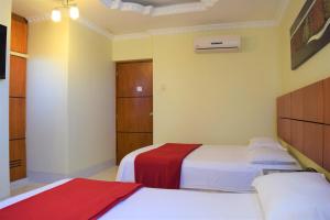 Voodi või voodid majutusasutuse Hotel Murali - Cerca del Aeropuerto de Guayaquil toas