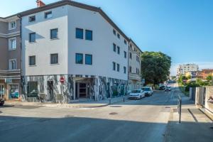 a white building on the side of a street at Exclusive City Apartments in Pula