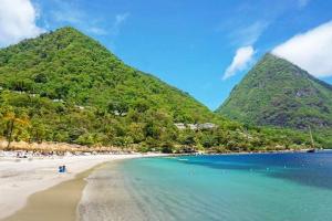a view of a beach with mountains in the background at Sea Piton View Apartment- Location, Convenience, Modern Living in Soufri&egrave;re