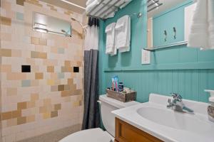 a bathroom with a white toilet and a sink at Netarts Surf Inn in Tillamook