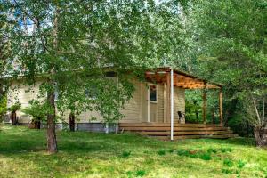 a small house with a gazebo in a yard at Russell Falls Holiday Cottages in National Park